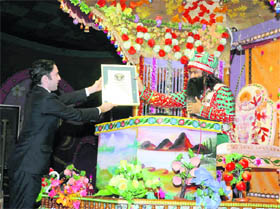 Jack Brookbank, adjudicator of the Guinness Book of World Records, hands over a certificate of record to Dera Sacha Sauda chief Gurmeet Ram Rahim Singh in Sirsa. 
