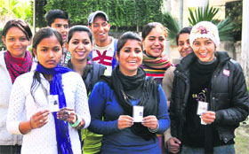 Enthusiastic first-time voters holding their voter cards which were issued on Wednesday in Jalandhar.