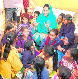  Bathinda MP Harsimrat Kaur Badal interacts with schoolgirls in Majitha on Wednesday. 