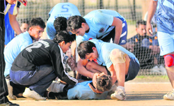 A player falls while taking a hit during the All-India Inter-University Handball Championship in Chandigarh on Friday. 