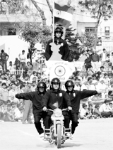 Policemen hold aloft the Tricolour while performing a motorcycle stunt at Shivaji Stadium in Panipat on Thursday.