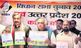 Congress leaders Jairam Ramesh (C), Pramod Tiwari and Anugrah Narayan Singh release the party vision document in Allahabad on Friday