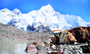 Ranjit Bajaj holds aloft the Tricolour after his record-breaking swim in the Pumori Glacial Lake