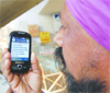A man reads an SMS sent by a candidate on his mobile in Amritsar.