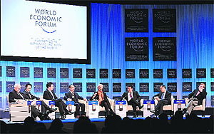 Christine Lagarde (C), managing director of the International Monetary Fund (IMF), addresses participants on the Global Economic Outlook 2012 at the World Economic Forum (WEF) congress centre in the Swiss resort of Davos on Saturday. The global elite has talked itself into an upbeat frame of mind as the Davos forum nears its climax, but the Greek debt crisis still hangs heavily over the proceedings