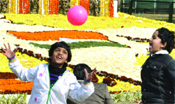 Children enjoy the bright sun at the Rajpath in New Delhi on Saturday. 