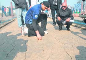 Off-spinner Harbhajan Singh inspects a cricket pitch at his academy in Jalandhar on Saturday