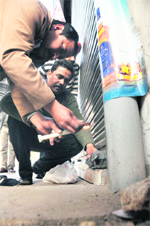 Officials of the Excise and Taxation Department seal a liquor vend in Ludhiana 