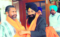 SAD-BJP candidate Sharanjit Singh Dhillon honours a farmer at Bajra