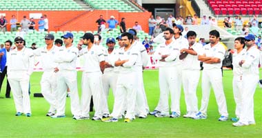 Dejected Indian players stand on the field after they were defeated by Australia by 298 runs in the fourth Test in Adelaide on Saturday
