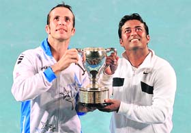 Still Setting the Paes: Leander (R) and his partner Radek Stepanek pose with the trophy after beating Bob Bryan and Mike Bryan in the men's doubles final in Melbourne on Saturday