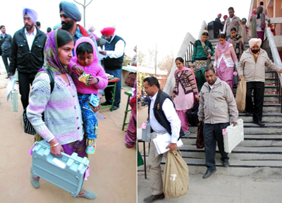 Carrying election-related material, polling staff head for their respective polling stations, at the Government Polytechnic College in Bathinda on Sunday. 