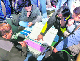 A trainer gives tips to election employees at the district election office at Roshanabad.