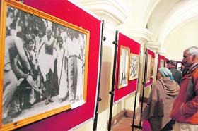 People watch a photo exhibition on the life of Mahatma Gandhi and freedom fighters of Himachal at the Gaiety Theatre in Shimla on Sunday