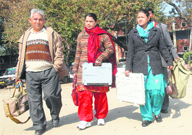 Polling staff carry EVMs and poll material in Jalandhar. 