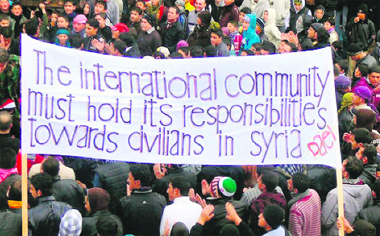 Syrian protesters hold a banner during an anti-regime demonstration in the southern city of Daraa. 