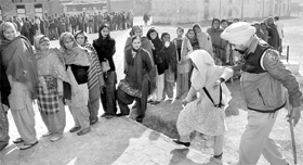 Woman voters stand in a queue at a polling booth near Ropar.