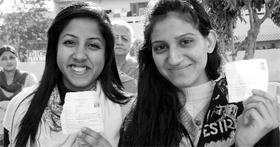 Girls who came to vote for the first time show their ID cards at Phase II in Mohali on Monday.
