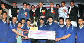 Members of the Chandigarh team with their trophy after winning the first Chaudhary Ranbir Singh Hooda Volleyball Championship at Sector 3, Panchkula, on Monday.