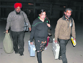 Poll staff carry the EVM back after voting at Dera Bassi on Monday.