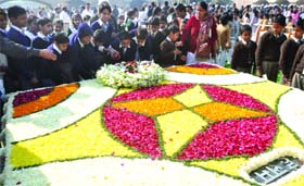 Schoolchildren pay homage to Mahatma Gandhi at Rajghat on Martyrs' Day in New Delhi on Monday