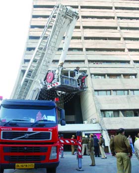 Security personnel perform a mock drill at the NDMC building near Jantar Mantar in New Delhi on Monday