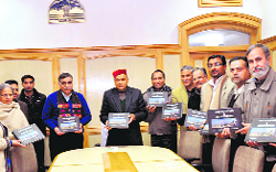 Chief Minister PK Dhumal releases a book titled Man, Mountain and Architecture, in Shimla 