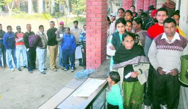 Voters stand in long queues to cast their votes in Jalandhar on Monday.