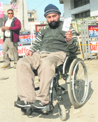 A differently abled voter on a wheelchair to cast his vote in Jalandhar on Monday. 