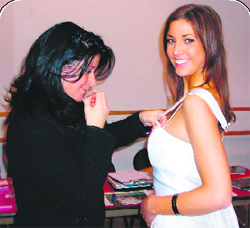 A designer gives a fininshing touch to her creation