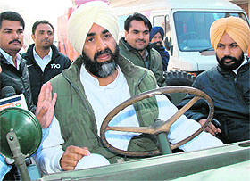 Manpreet Badal arrives at a polling station in a jeep.