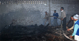 Fire-fighters in action (top) at an old railway godown on Thandi Sadak in Bathinda where fire broke out on Tuesday.