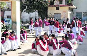 Girl students of Bhalla Municipal Intermediate School bask in the sun as schools reopened after Assembly polling in Haridwar on Tuesday