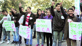 UP IN ARMS: Students hold a demonsration against the proposed fee hike at Himachal Pradesh University in Shimla on Tuesday.