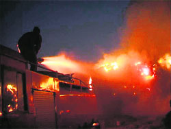 Fire brigade staff try to control fire at a solvent plant in Nilokheri (Karnal district) on Monday night. 