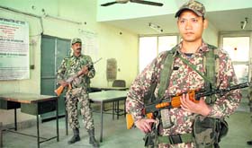 Paramilitary forces guard a strong room, where EVMs have been kept, at Raizada Hans Raj Stadium in Jalandhar on Tuesday