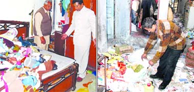 Amandeep Mittal, director, Punjab Agro Food Corporation, shows his ransacked house in Jalandhar. Yashpal Setia, owner of the general store, collects the scattered goods