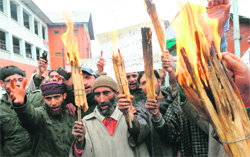 Supporters of MLA, Langate, Engineer Rasheed raise slogans as they hold torches during a demonstration against Minister of State for Education Peerzada Mohammad Sayeed in Srinagar 