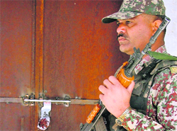 A jawan stands guard outside a room where EVMs have been kept, in the Government College for Women, Ludhiana, on Tuesday.