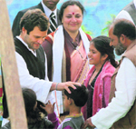 Congress general secretary Rahul Gandhi interacts with children at an election rally in Sitapur district of Uttar Pradesh