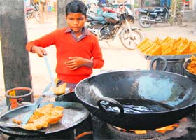 A child works at a sweets shop despite ban on child labour in Amritsar on Wednesday