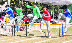 Students of Strawberry Fields World School take part in a hurdles race at their annual sports day on the school campus in Sector 26 