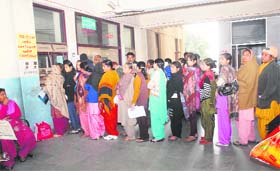Patients queue up at a counter in the Civil Hospital Wednesday