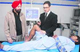 Dr Sanjiv Goel checks a patient with the new stryker navigation system in Jalandhar