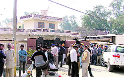 Residents gathered outside the house where the boy and girl were killed