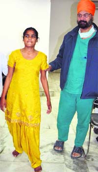 Dr Avtar Singh with the girl whose hip joint was replaced in Amritsar