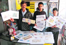 Rajan Arora along with sons Krishna and Madhav shows his collection of stamps in Amritsar