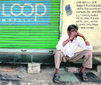 A closed shop displaying the Loop mobile logo on its shutter in Mumbai on Thursday.  