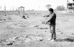 Satpal, a resident of Sohana, points to the site where the dead are buried. The site is close to houses under construction in Sector 77.