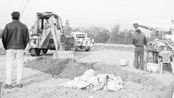 A JCB machine digs a trench to prevent direct access to the Chandigarh-Ambala highway on Thursday. 